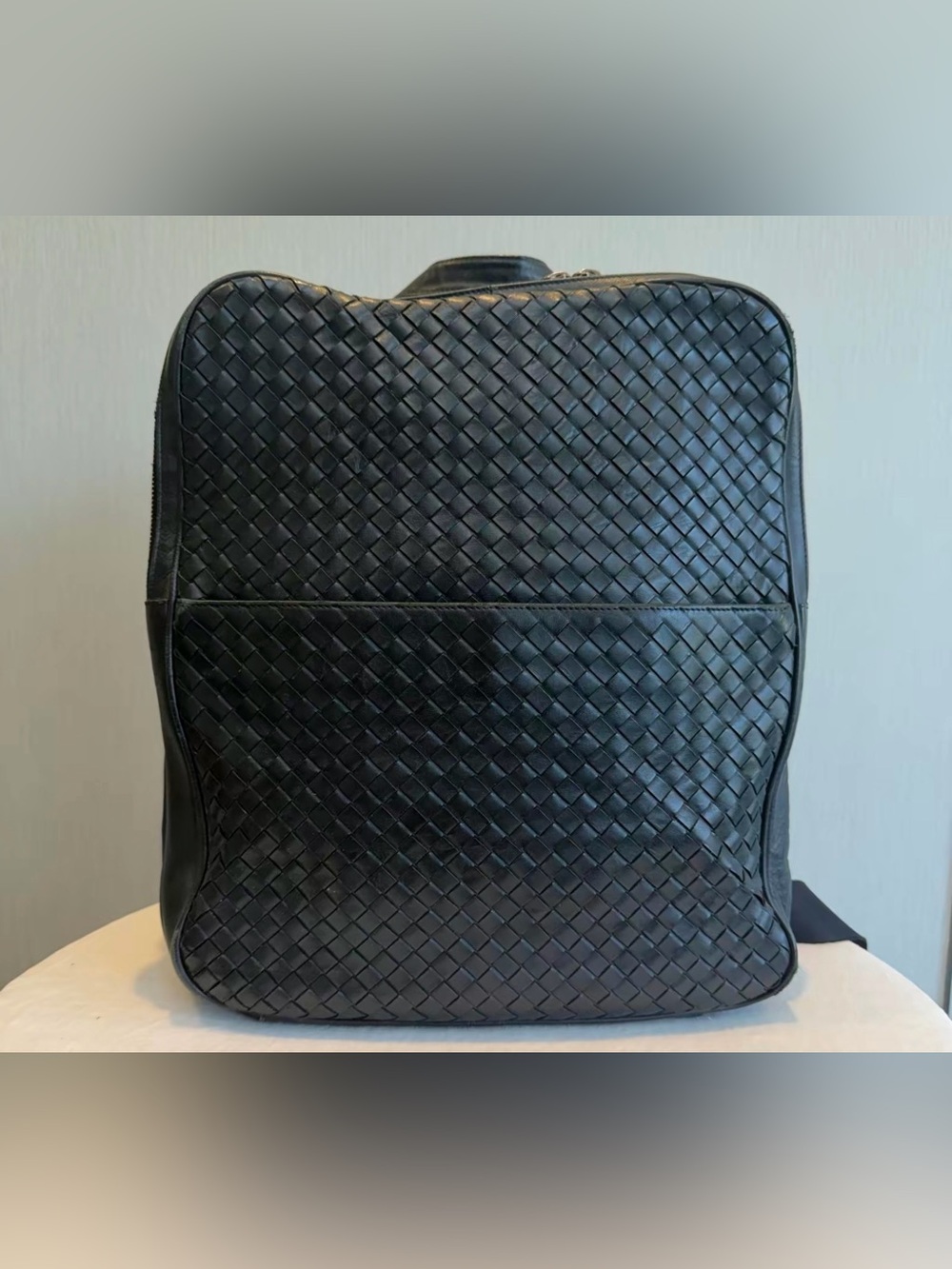 Bottega Veneta Intrecciato (woven leather) backpack in black.